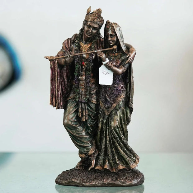 A beautiful and intricate bronze statue depicting Radha and Krishna